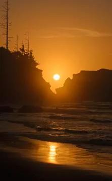 Setting Sun Through Coastal Rocks Photos