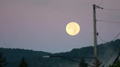 Setting supr moon behind a mountain cinematic timlapse video Stock Footage 259435085