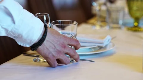 Setting a table for fine dining in an elegant restaurant Stock Footage 320304334