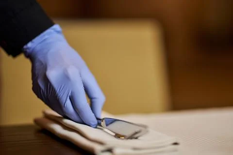 Setting tables up only with disposable gloves on Stock Photos