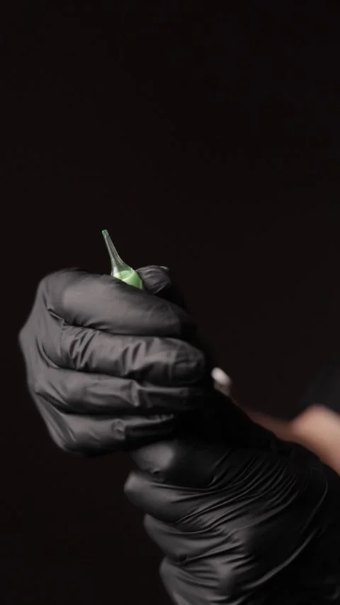 Setting Up the Tattoo Needle in the Tattoo Machine Stock Footage 300480954