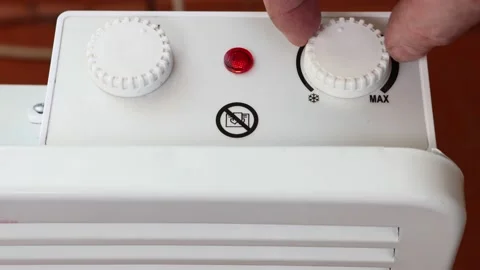 Setting temperature in adjustable thermostat of convector heater. Video stock 236123212