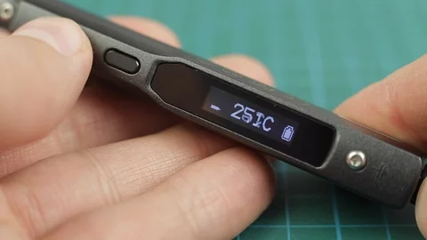 Setting temperature and heating digital soldering iron with display, on table Video stock 128820616