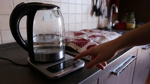 Setting the temperature and heating water in the modern kettle on a table Stock Footage 127979646