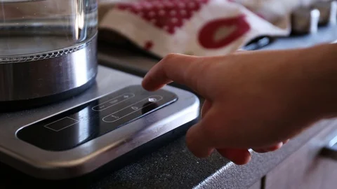 Setting up the temperature and turning on the electronic kettle Stock Footage 127985283