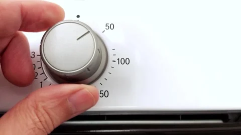 Setting the Temperature- Hand Turns Dial on Modern Oven Stock Footage 318208163