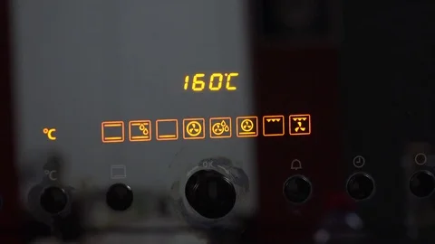 Setting the temperature on an oven to 160 degrees Stock Footage 73254934