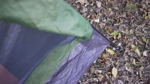 Setting up a tent in the forest. Camp in nature. Preparation of the place of Stock Footage 166680348