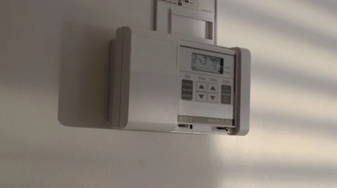 Setting a thermostat to 72 degrees and 66 degrees Stock Footage 47575984