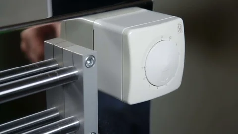 Setting a thermostat dial Stock Footage 69847414