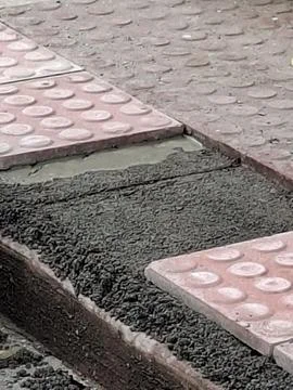 Setting tile floor on a sidewalk Stock Photos