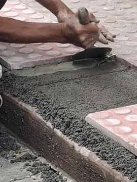 Setting tile flooring on sidewalk Stock Photos