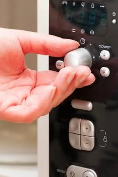 Setting a timer on the microwave oven Stock Photos