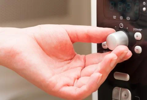 Setting a timer on the microwave oven Stock Photos