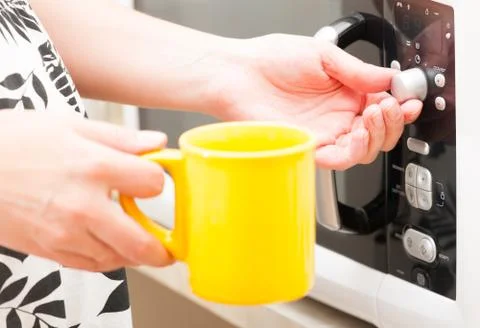 Setting a timer on the microwave oven Stock Photos