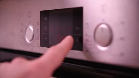 Setting the timer on an oven for perfect cooking results. Stock Footage 302540585