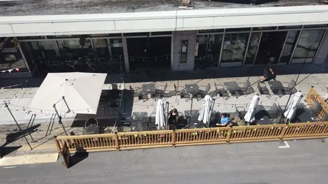 Setting up an umbrella in a patio 4K Stock Footage 135168030