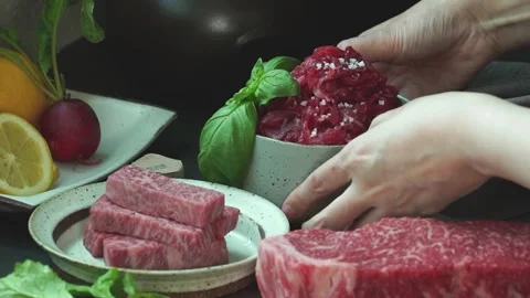 Setting up various raw meats on the table. Stock Footage 334358071