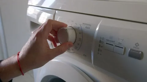 Setting Washing Machine Program, Starts Doing Laundry at Home, Press Button Video stock 296327442