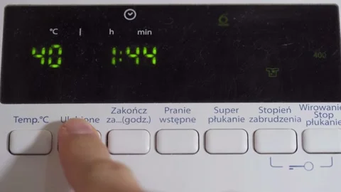 Setting the washing temperature as well as the degree of soiling and spin speed Video stock 145717990