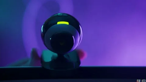 Setting webcam on top of a computer screen as it is recording and filming video Video stock 163812175