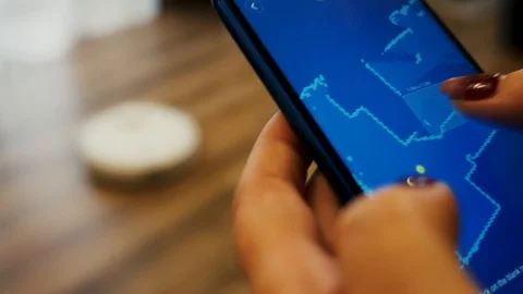 Settings on smartphone Vacuum Cleaner Robot Stock Footage 124310488