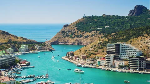 Settlement on the mt in the mountains. Yachts are floating in the bay. Time l Stock Footage 95651053