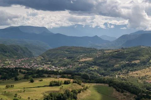 Settlement in valley surrounded with mountains Stock Photos