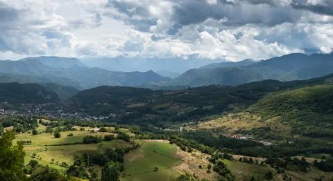 Settlement in valley surrounded with mountains Stock Photos