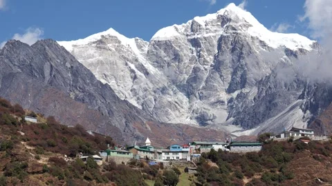 Settlement Is Village Of Sherpas On Background Of A Huge Snowy Mountain In Nepal Stock Footage 260385550