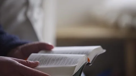 Settling down to read the  bible Stock Footage 247055536