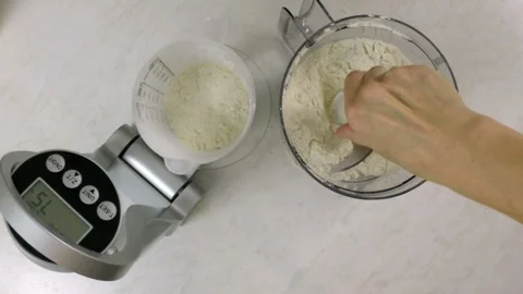 Setup cutting blade into food processor cup. Pouring flour. Stock Footage 97969431