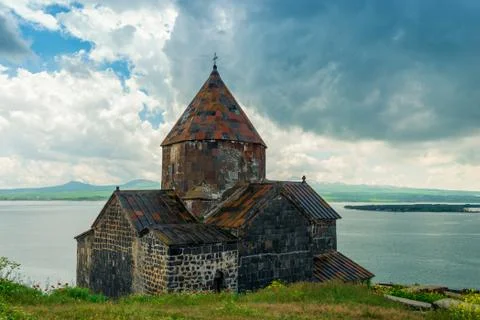 Sevan Monastery in Armenia on a cloudy summer day overlooking the lake Stock Photos