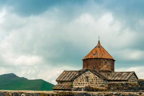 Sevanavank Monastery on a background of dark blue rain clouds, a landmark of  Stock Photos