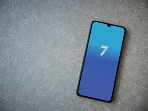 Seven app launch screen with logo on the display of a black mobile smartphone Stock Photos