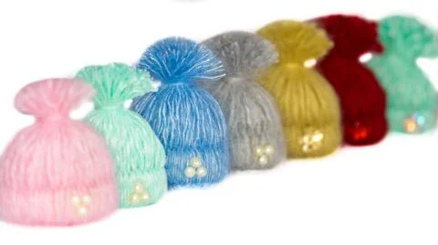 Seven beautiful multi-colored caps -. handmade brooches lined up waiting for Stock Photos