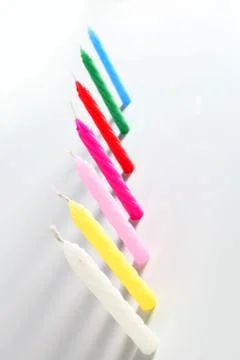 Seven colored candles Stock Photos