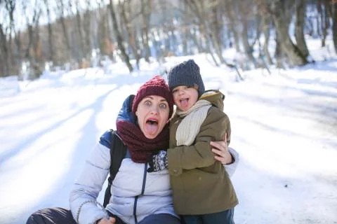 Seven having fun and sledding on the street in the snow Stock Photos