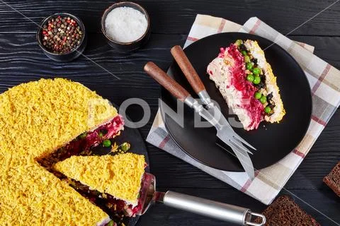 Seven layered salad on a black plate Stock Photos