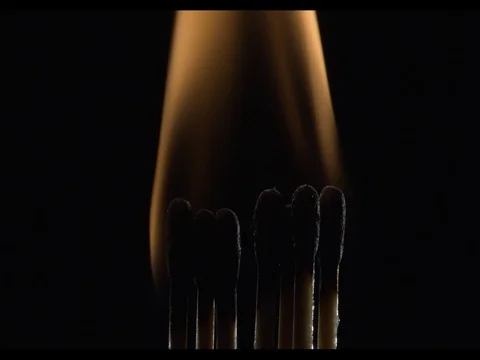 Seven matches light up and burning on a black background, close-up, slow motion Stock Footage 74343352