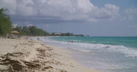 Seven Mile Beach Waves with tourists  Stock Footage 80270989