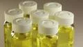 Seven rotating glass bottles with yellow liquid HD Footage