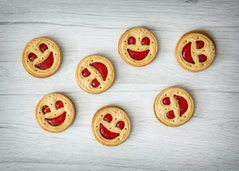 Seven round biscuits smiling faces, humorous food Stock Photos