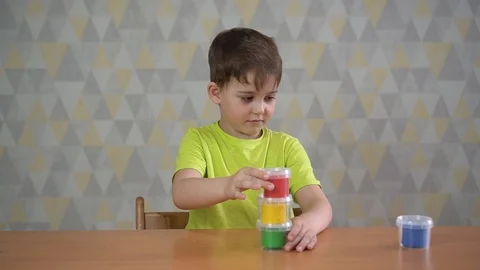 Seven-year-old boy playing with plasticine Stock Footage 128955874