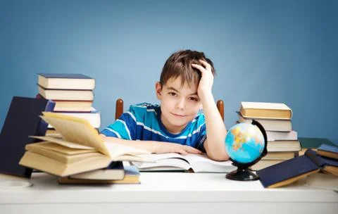 Seven years old child reading a book Stock Photos