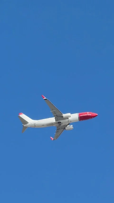 Several airplanes from different airlines fly one after another across the bl Stock Footage 306008288