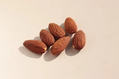 Several almond grains on a light background. Foto stock