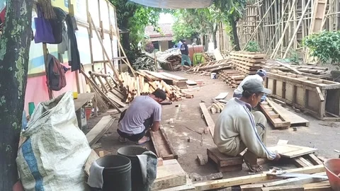 Several Asian construction workers are busy working together to repair Stock Footage 309902261