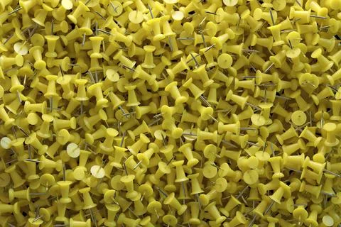 Several assorted colors of plastic push pins Stock Illustration