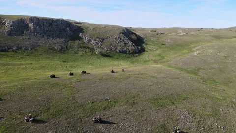 Several ATVs and a cyclist go up the hill Stock Footage 155307810